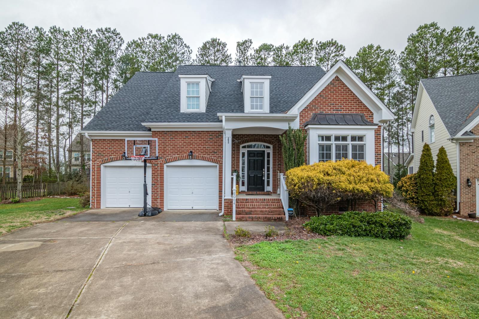 A brick suburban home on a tidy Southern street.